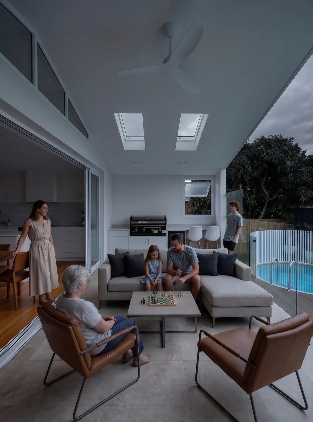 A covered outdoor living area beside a pool, facing south, in flat grey light